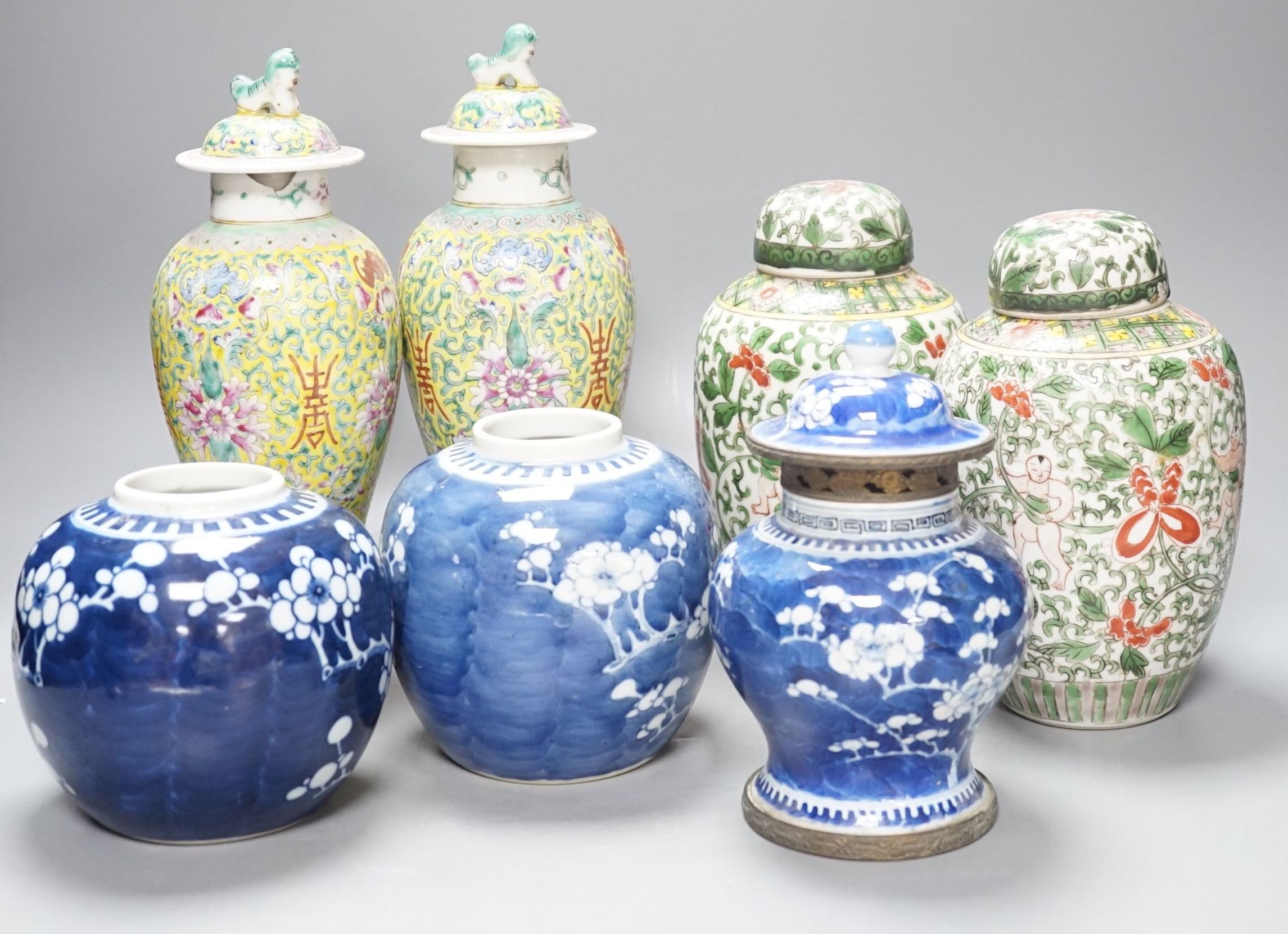 A pair of Chinese porcelain vases and covers, a pair of jars and covers, a metal mounted vase and cover and two prunus jars, (7), Tallest vases 26.5 cms high including cover.